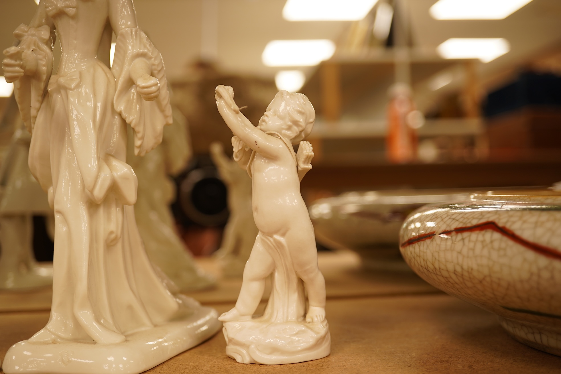 Two Nymphenberg white glazed figures, after Bustelli and two similar cherubs (4) figure 19 cm high